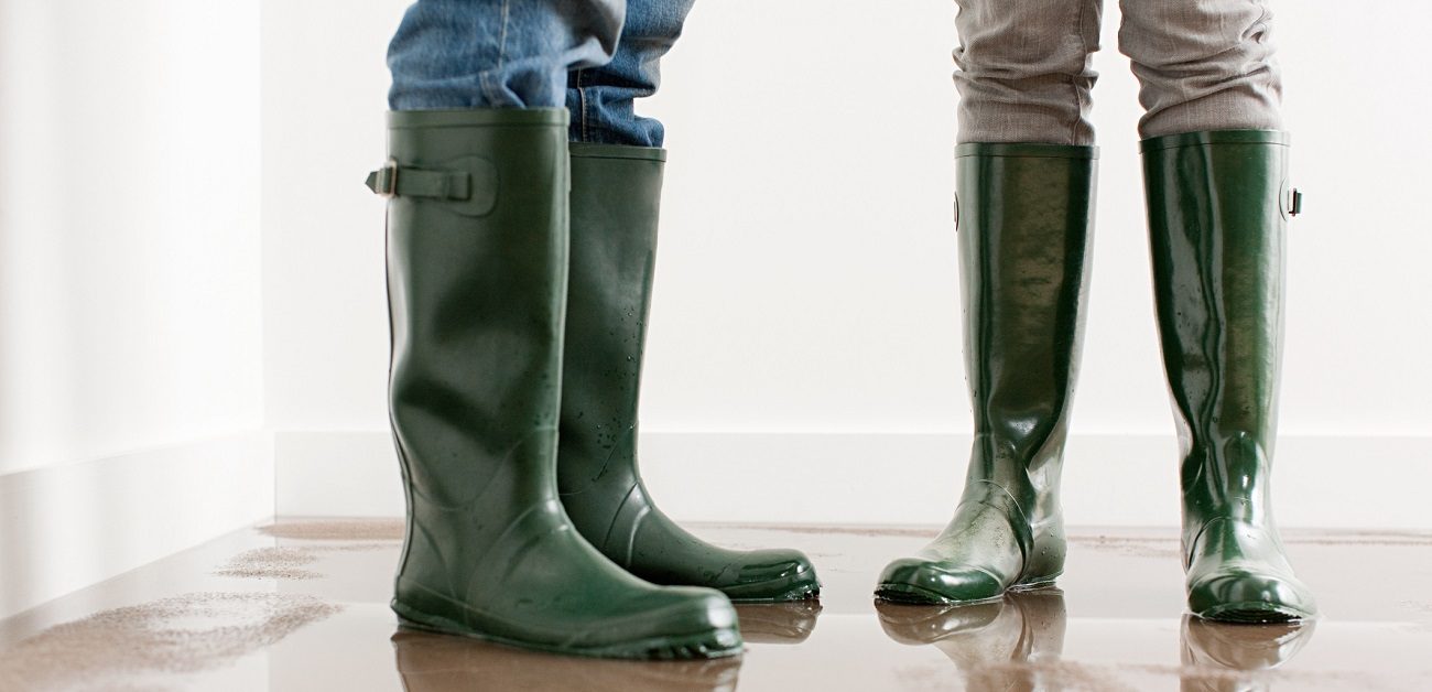 people standing on flooded floor in rainboots