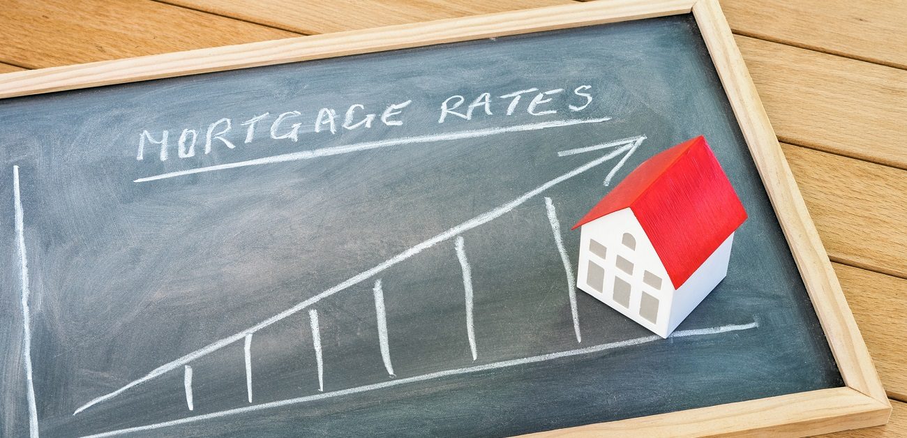 Rising mortgage rate graph on a blackboard