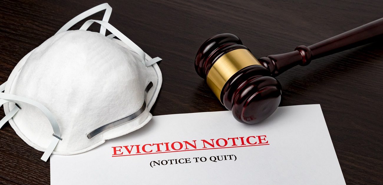 Eviction notice document with gavel and N95 face mask