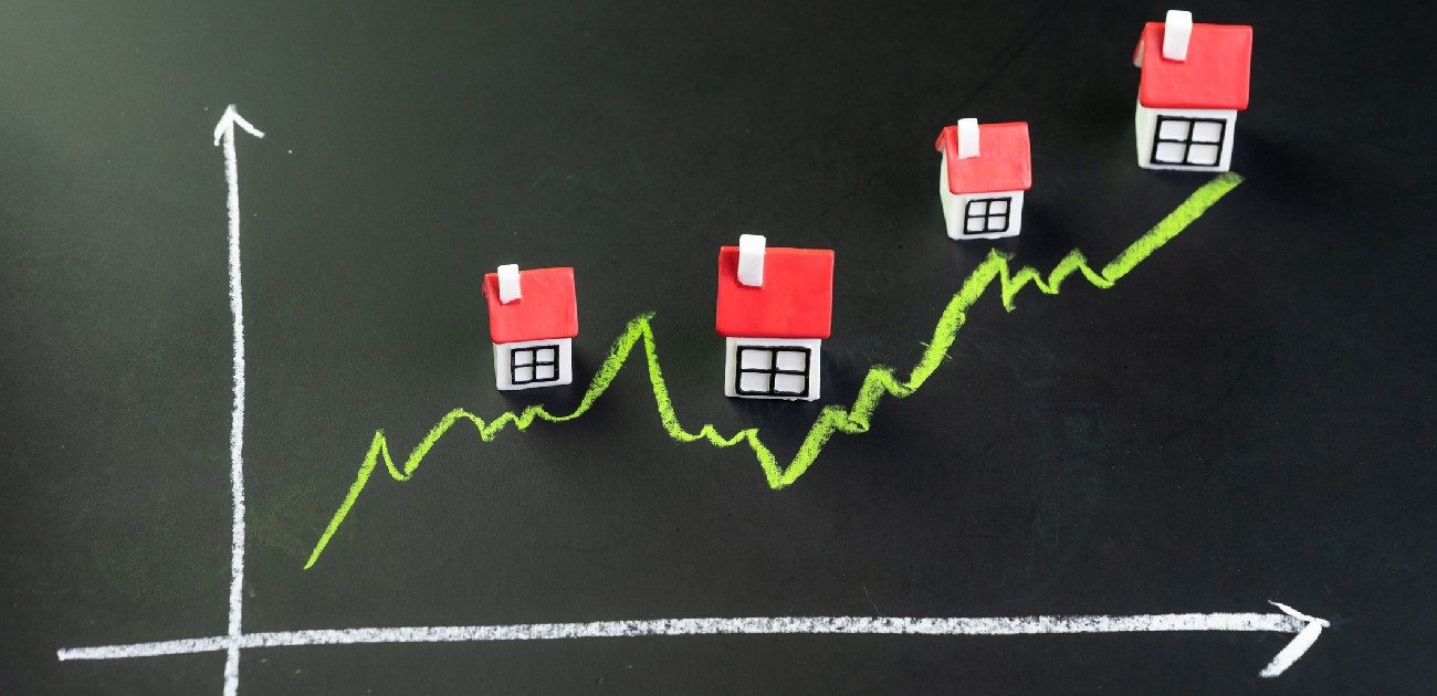 A picture of a line graph on a chalkboard with houses drawn at various peaks of the line.