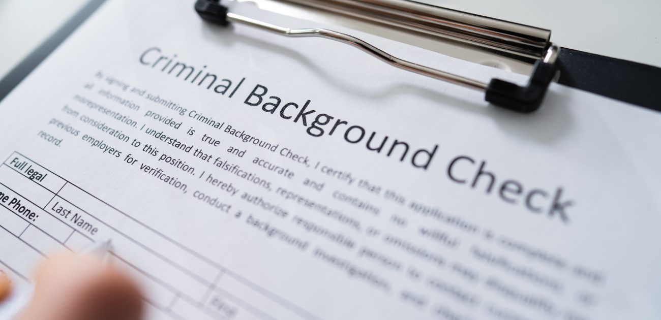 A picture of a criminal background check form on a clipboard.