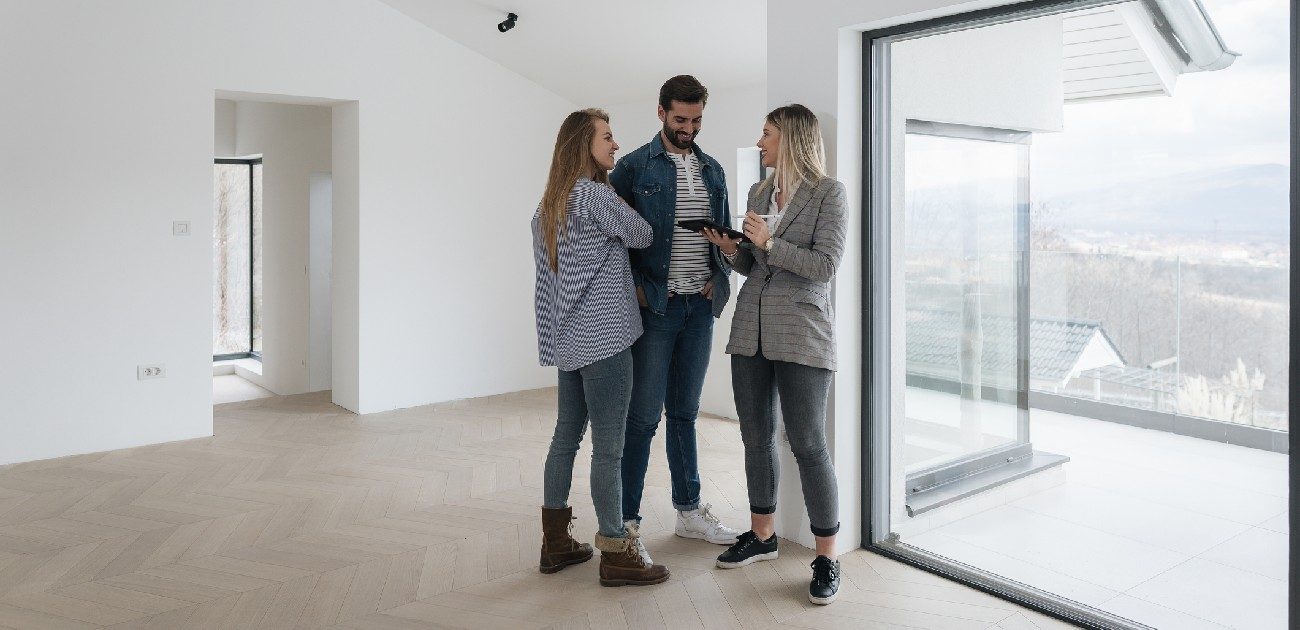 Three people in conversation while visiting a home.