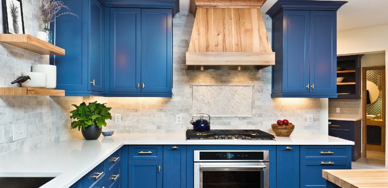 A picture of a newly renovated kitchen with with a blue and white color scheme.
