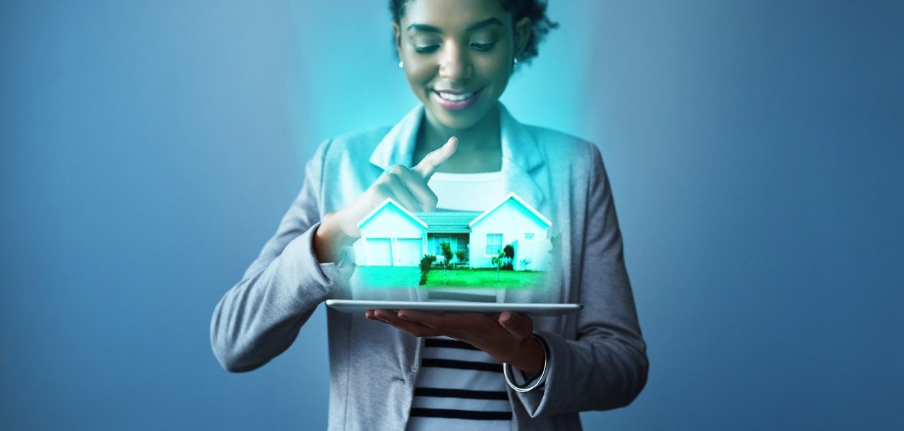 young businesswoman using a digital tablet with property graphics