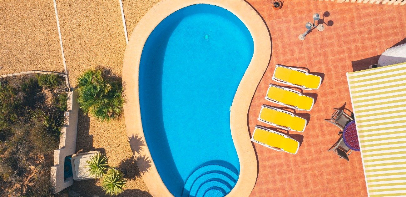 An aerial photograph of an in-ground swimming pool.
