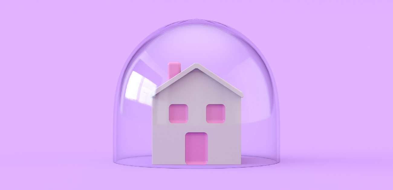 A picture of a house miniature enclosed in a bubble, resting on an a light-purple background.