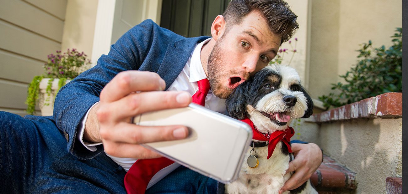 Businessman Taking Selfie with Dog