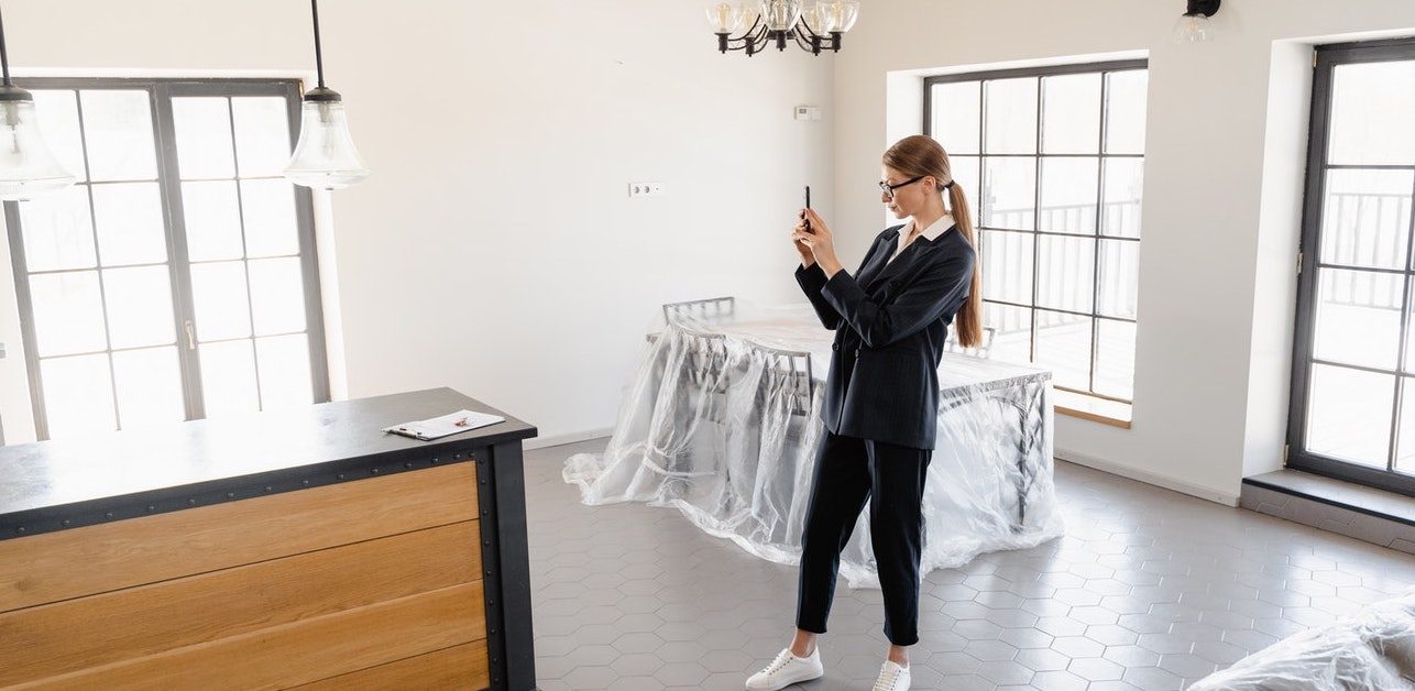 Real estate agent giving virtual tour of house with phone