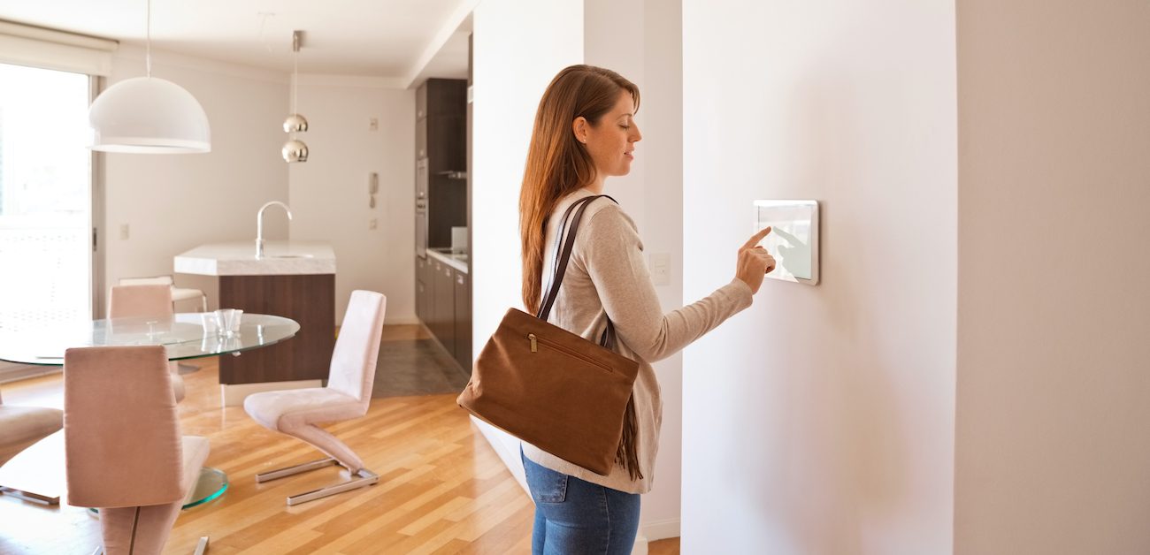 Woman using smart switch on wall