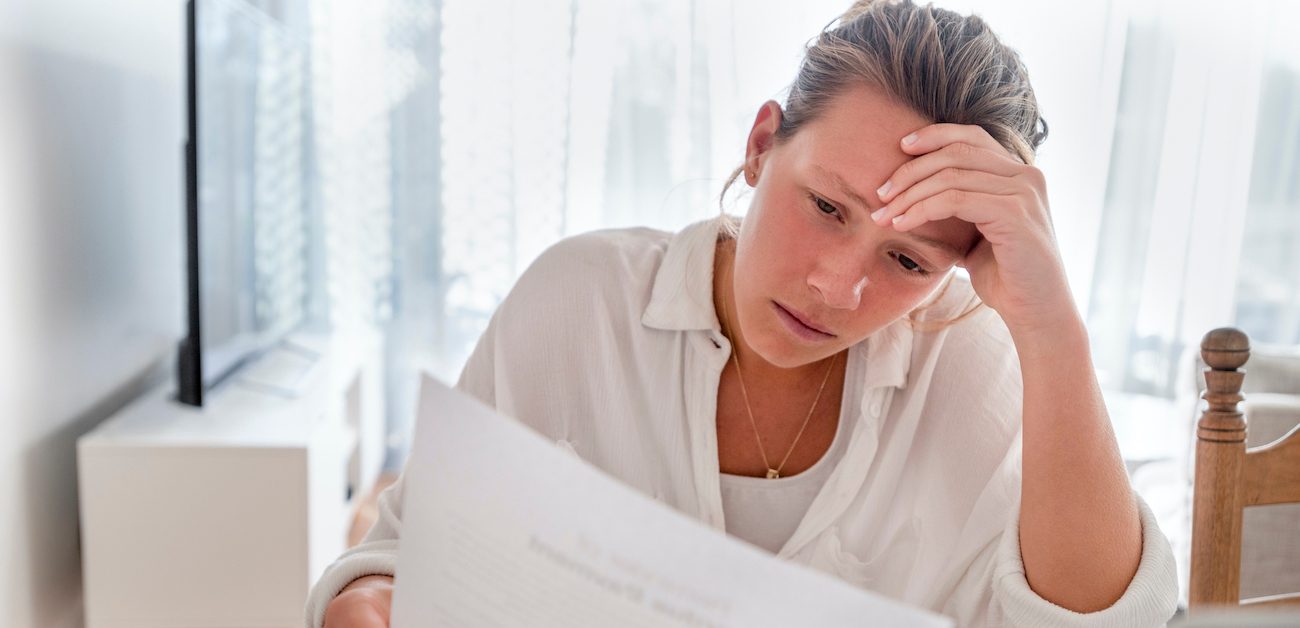 Woman reviewing contract looking concerned