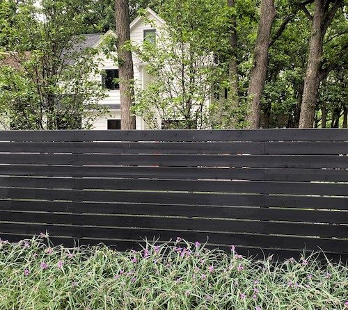 Dark colored horizontal slat fence
