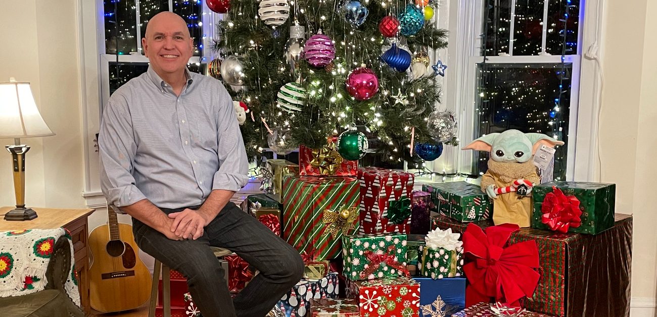 Chicago real estate agent Dan DePaepe sits in front of his Christmas tree, adorned with ornaments and lights.