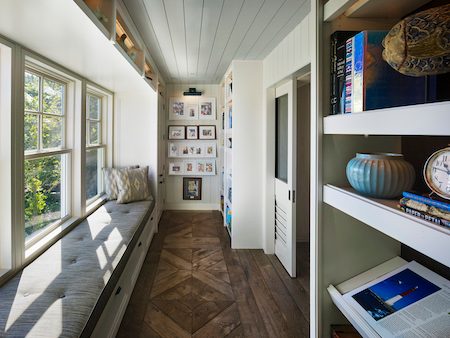 Extra storage above and below windows with creative use of shelving.