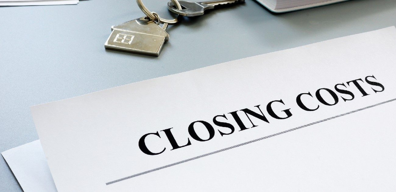 A picture of a document on a desk with the header of "Closing Costs" at the top.