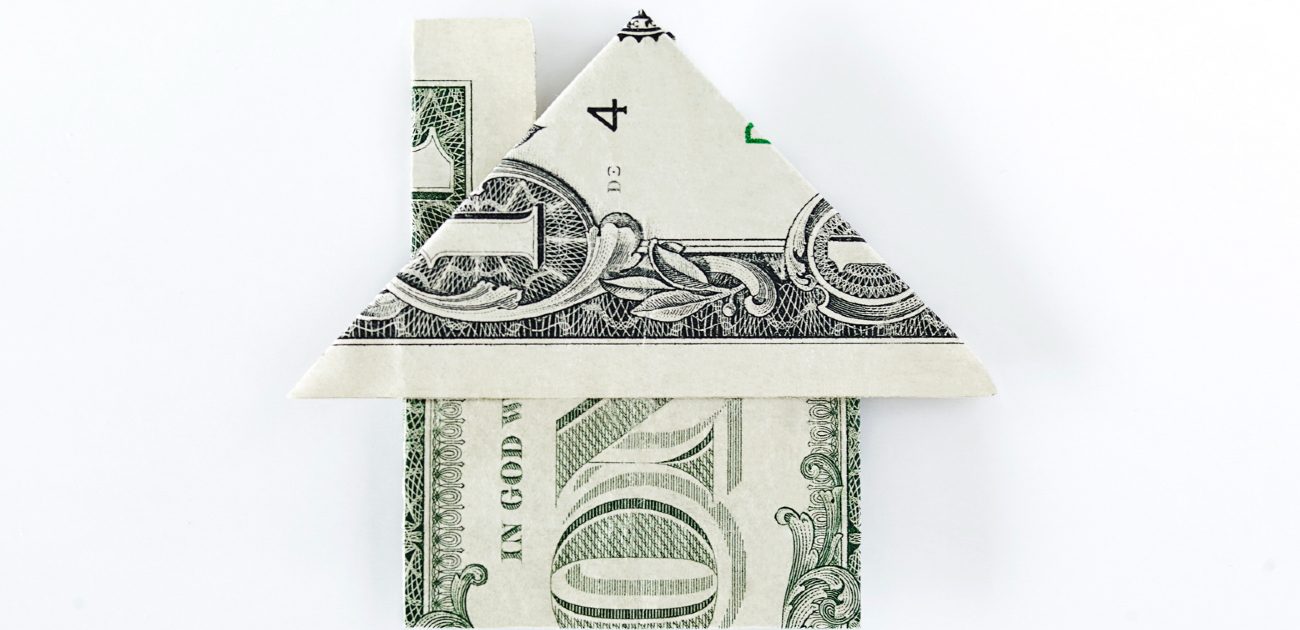 An image of a $1 bill folded into the shape of a house.