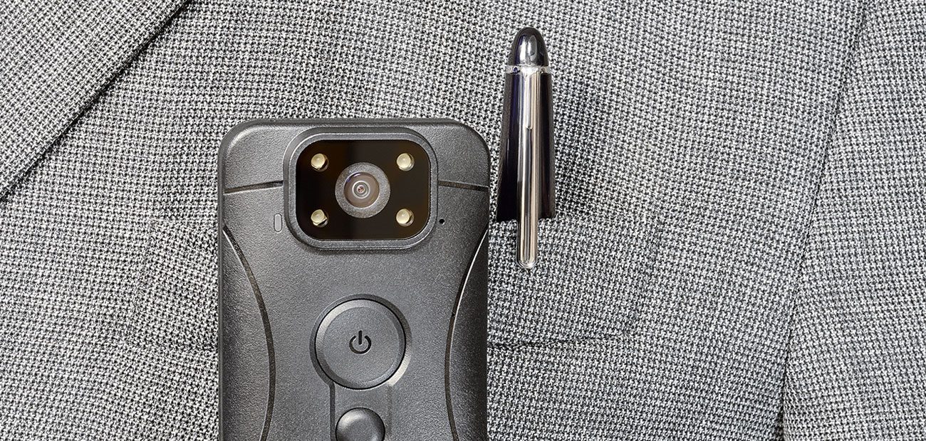 body cam on jacket pocket with pen