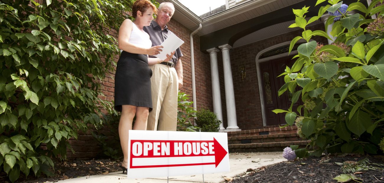 couple looking at sell sheet at open house