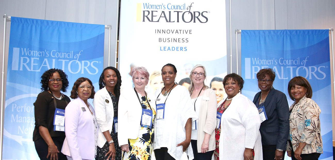 Members pose in front of signage during the Women's Council of REALTORS® Networking Reception & Best of Women's Council Awards.