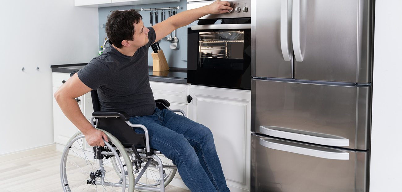 Man in Wheelchair Using Adapted Oven