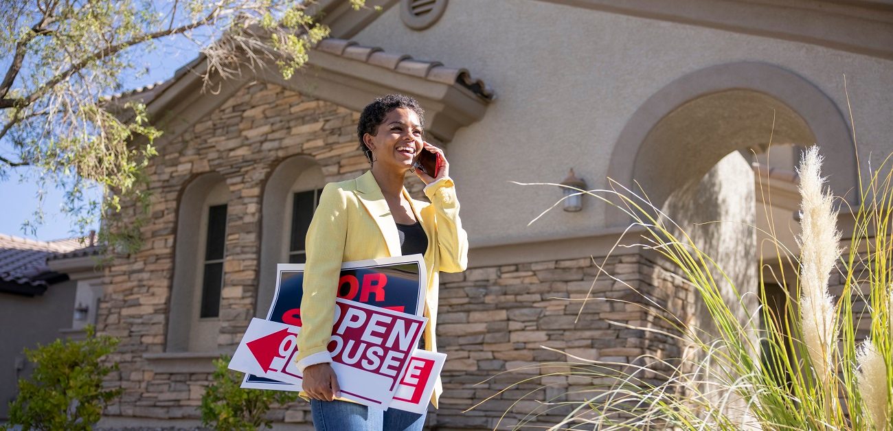 Real estate agent with open house signs