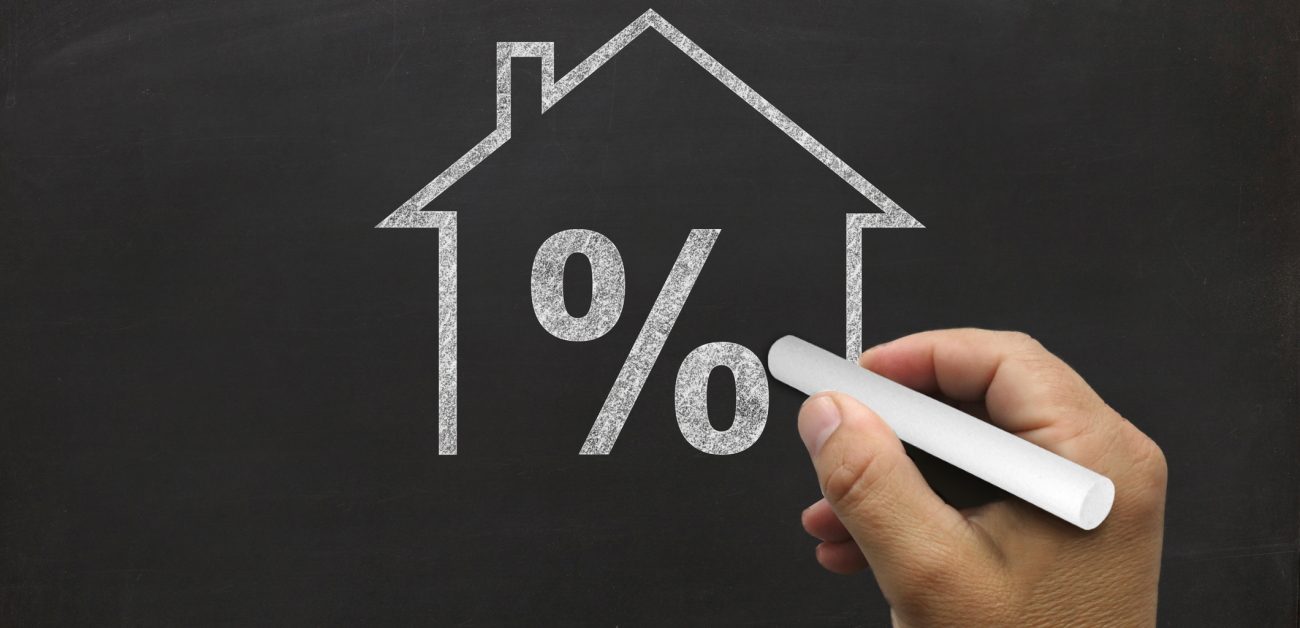 A home with a percent sign drawn on a chalkboard