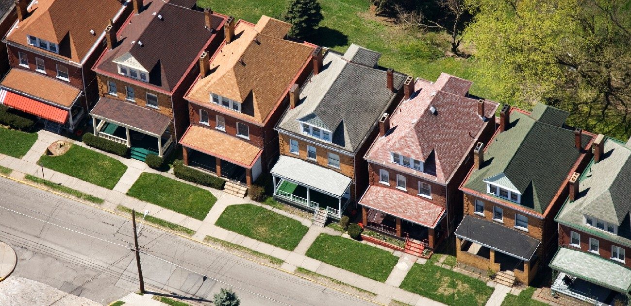 An aerial photograph of a residential neighborhood showing near-identical houses.