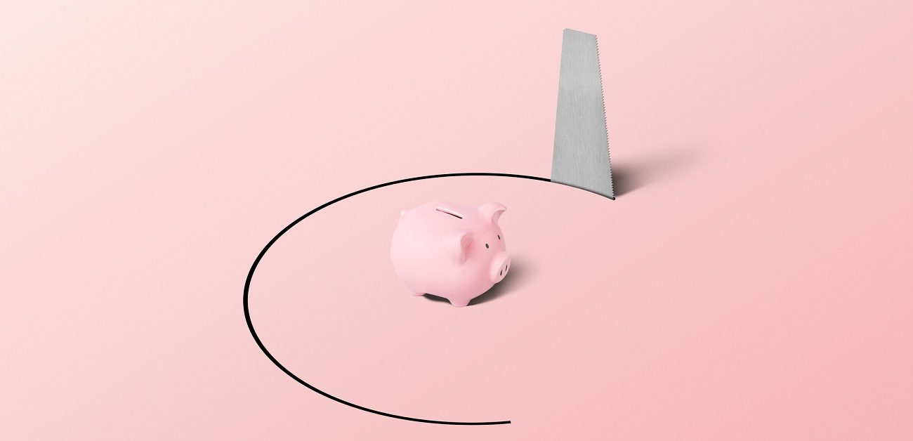 Piggy bank in a trapped position with a hand saw
