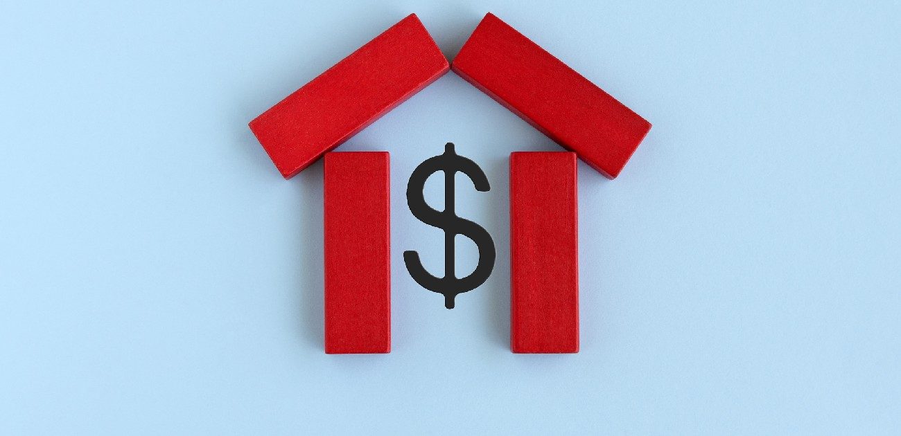 A picture of four red dominos laid flat in the shape of a house, with a dollar sign within the shape.