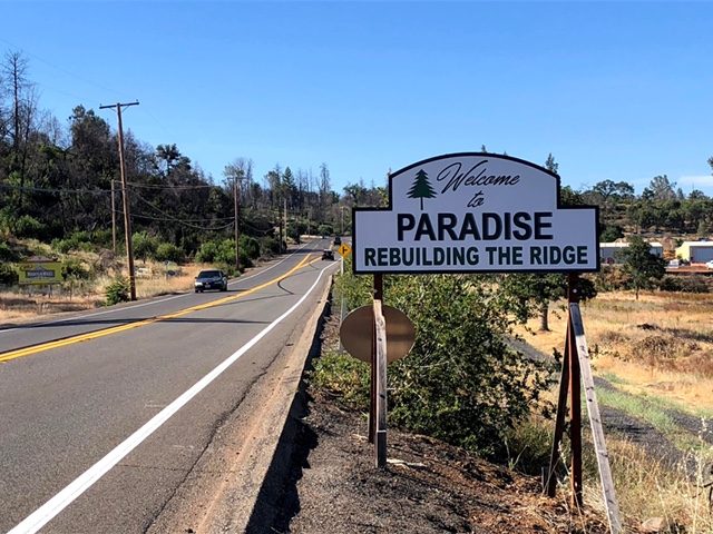 A picture of the welcome sign to Paradise, Calif., reading, "Welcome to Paradise" and "Rebuilding the Ridge"